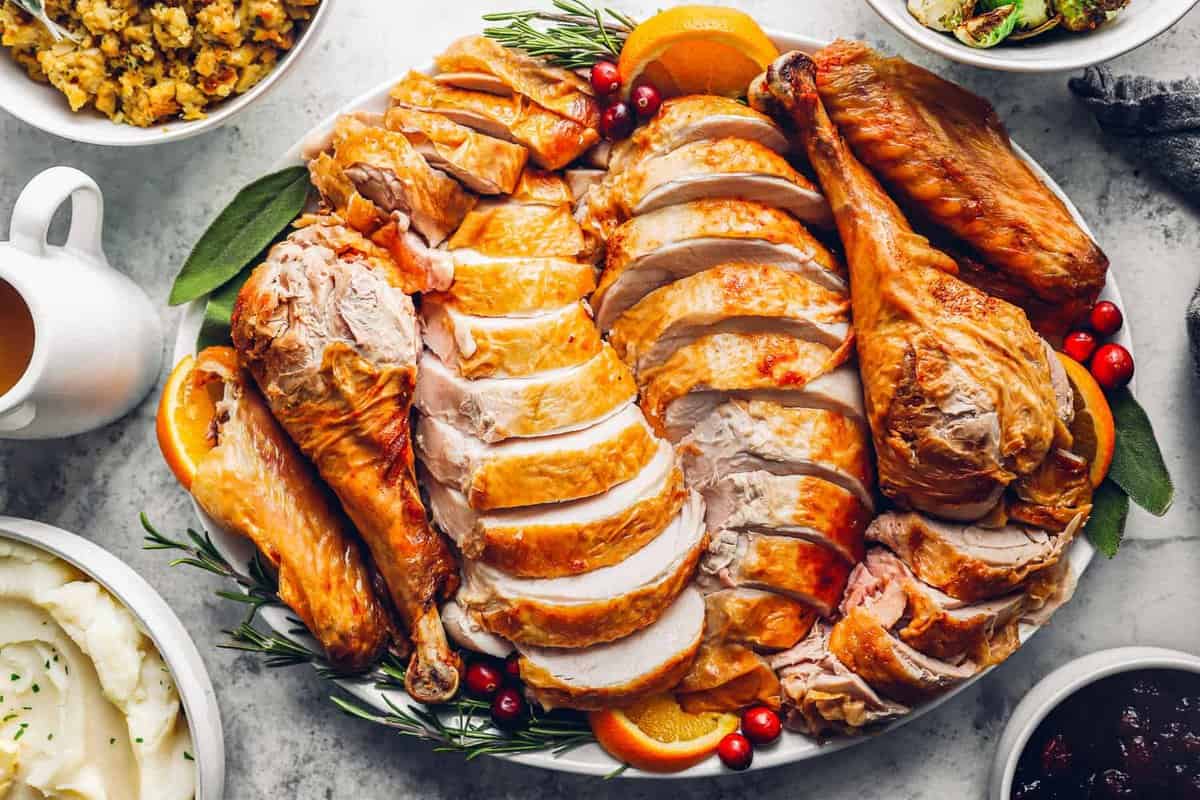 sliced deep fried turkey on a white serving plate.