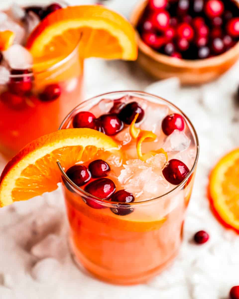 Orange cranberry sangria with ice and cranberries.