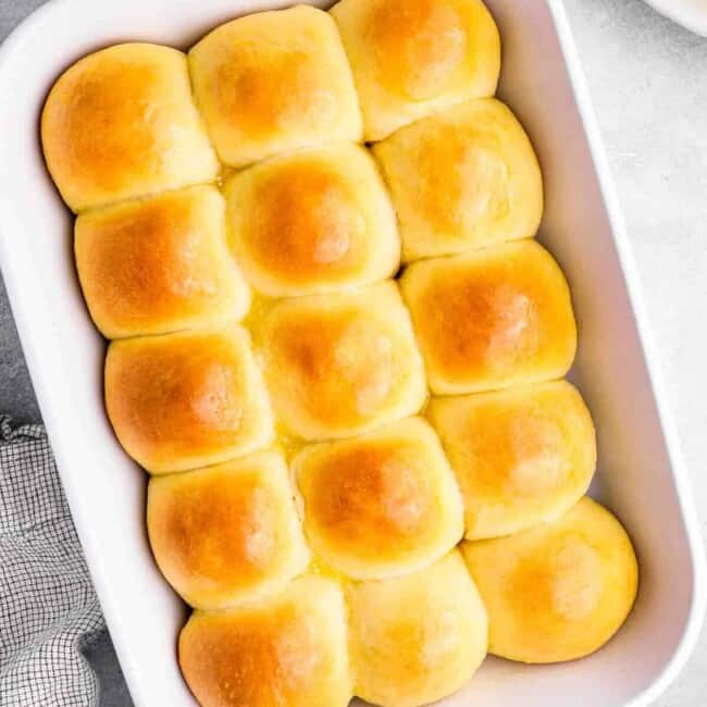 overhead view of 15 dinner rolls in a white baking dish.