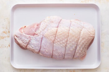 uncooked turkey breast on a white tray.