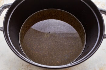 A pot filled with brown liquid on a table.