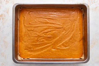 A baking pan with a pumpkin cake in it.