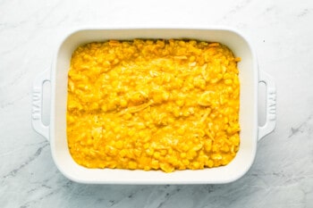 Corn casserole in a white baking dish.