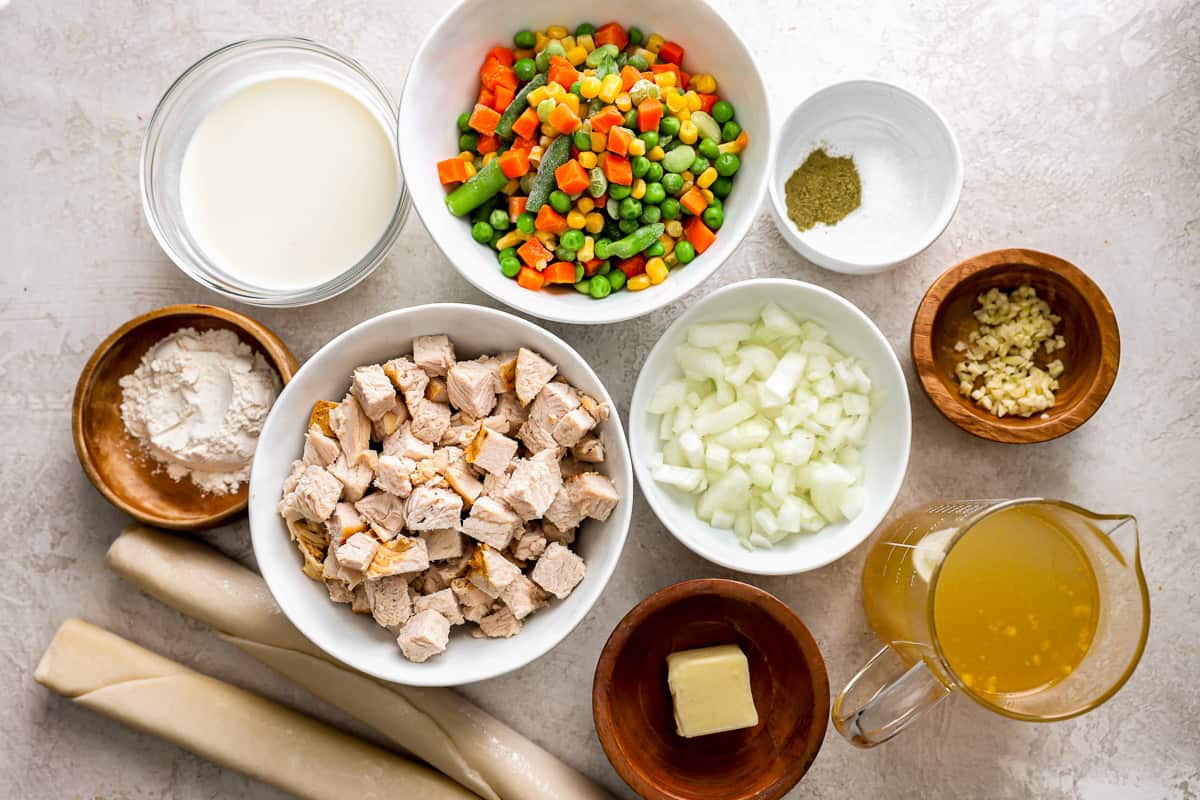 Ingredients for chicken tikka masala in bowls on a table.