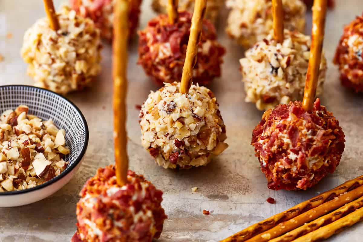 Mini cheese balls on pretzel sticks.