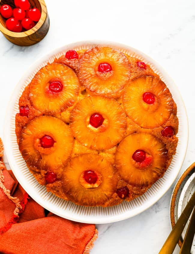 A pineapple upside down cake on a plate.