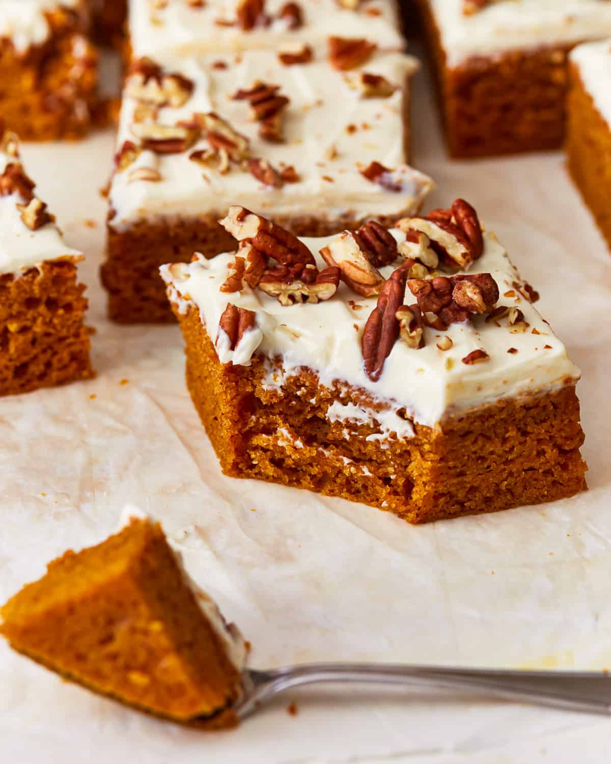 Pumpkin bars with cream cheese frosting and pecans.