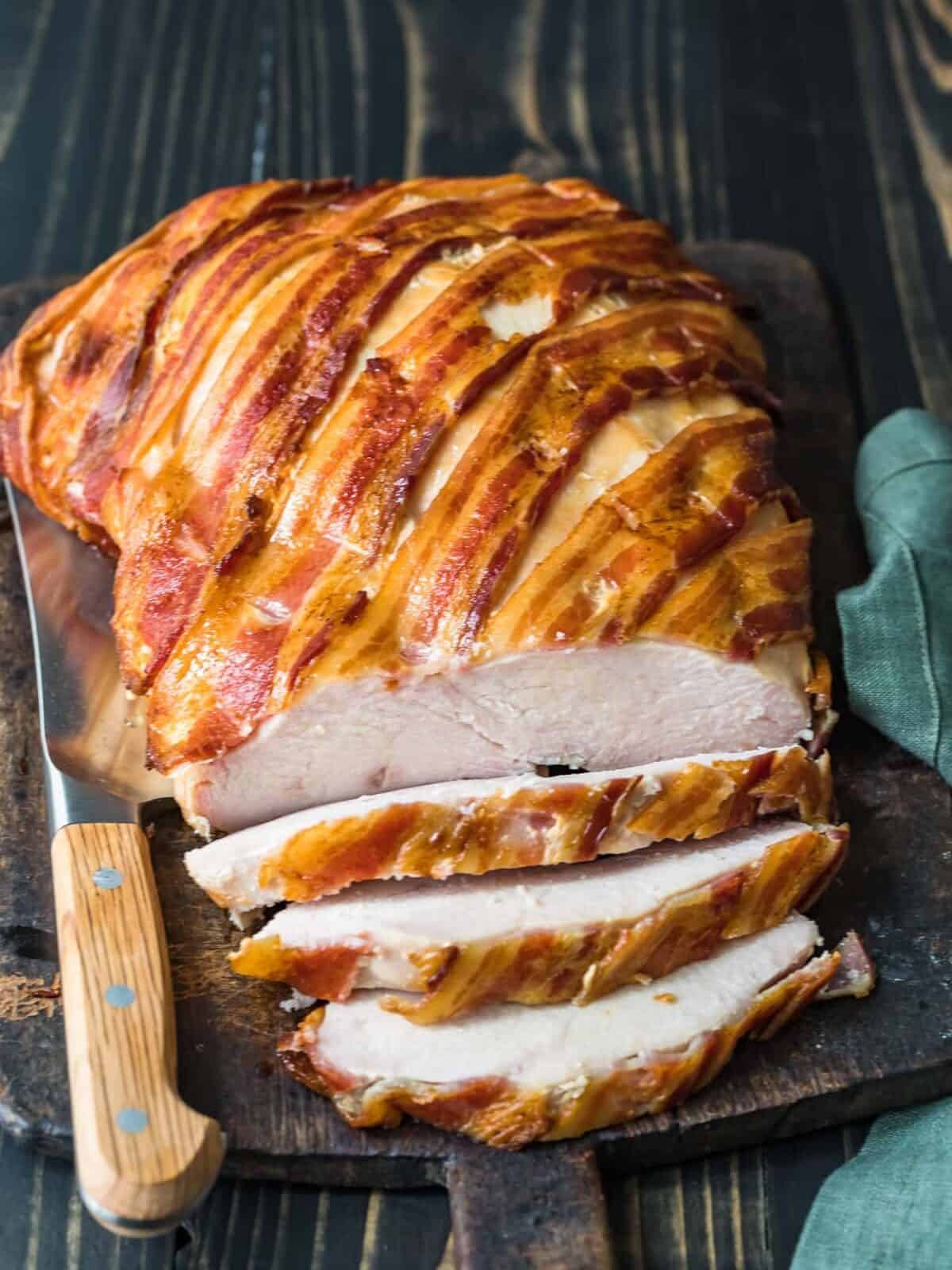 bacon wrapped turkey breast on a chopping board