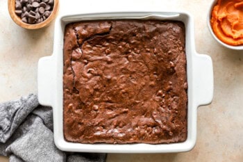 baked pumpkin brownies in a square baking pan.