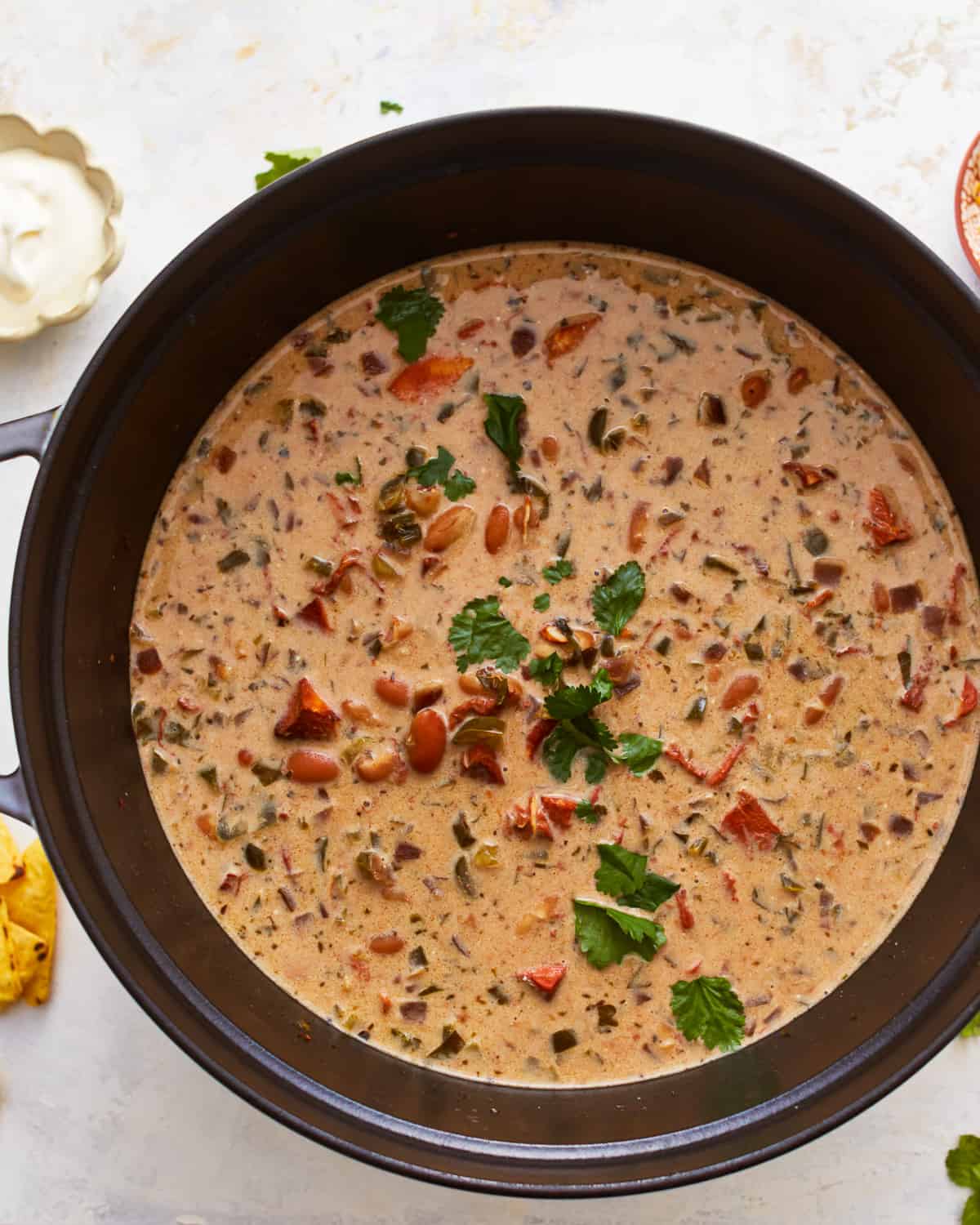 A pot of white bean chili with cream cheese and chicken.