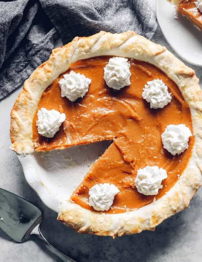 overhead view of a caramel pie with one slice removed