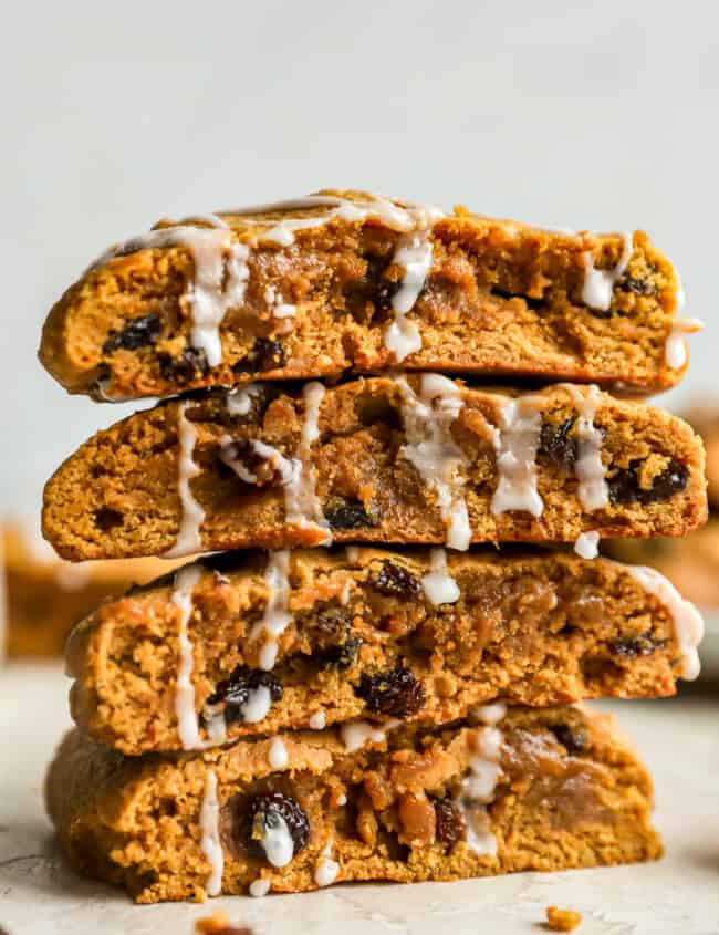 A stack of pumpkin raisin cookies with icing.