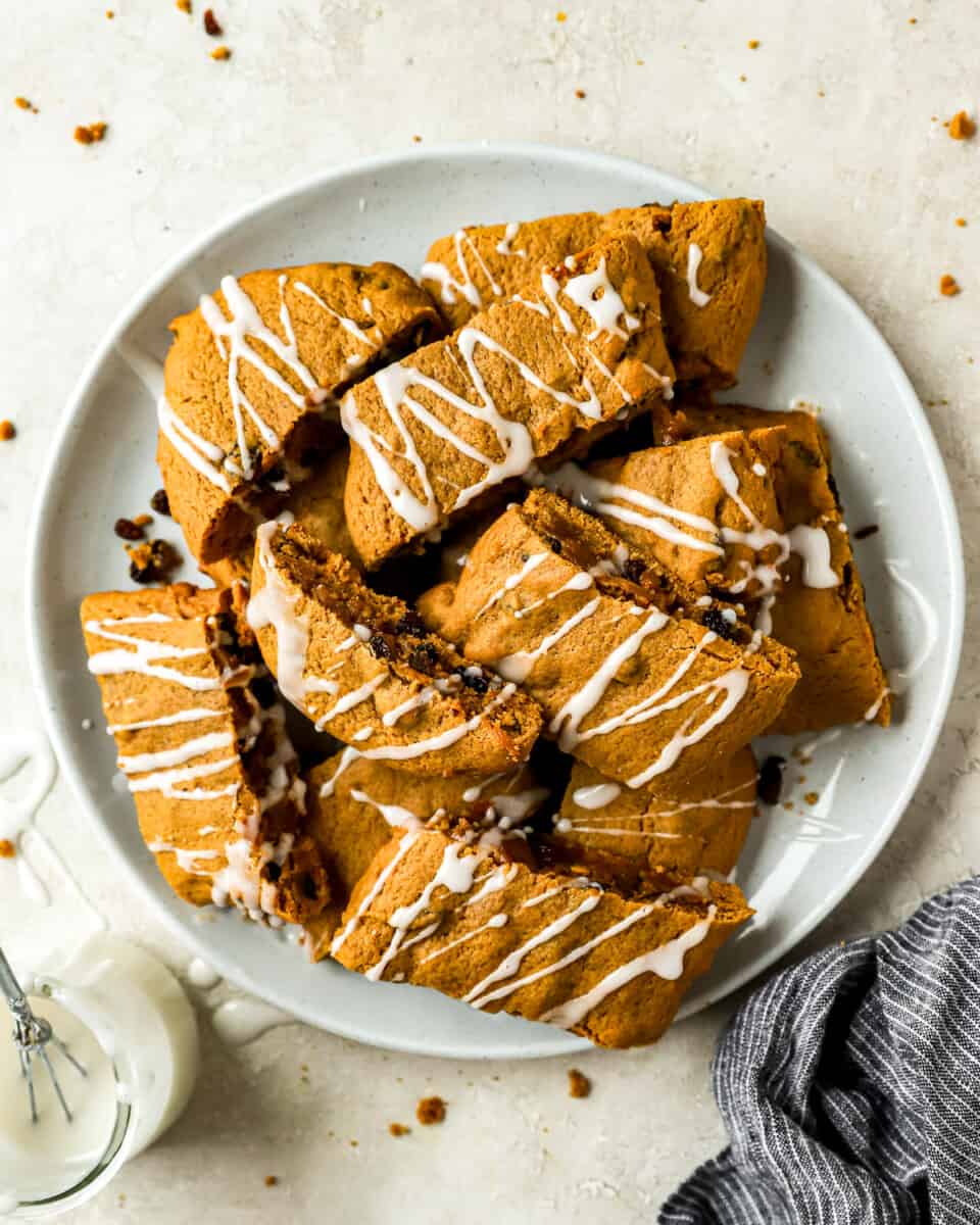 A plate of hermit cookie bars with icing.