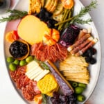 A platter with a variety of cheeses and crackers.