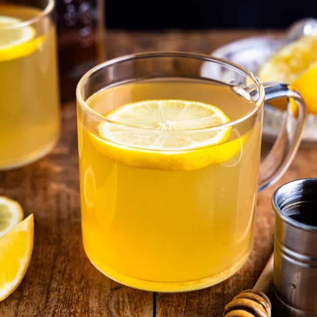 A cup of lemon tea with a slice of lemon.