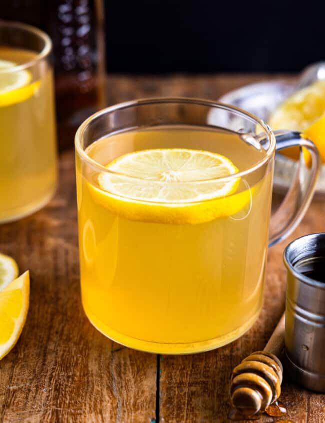 A cup of lemon tea with a slice of lemon.