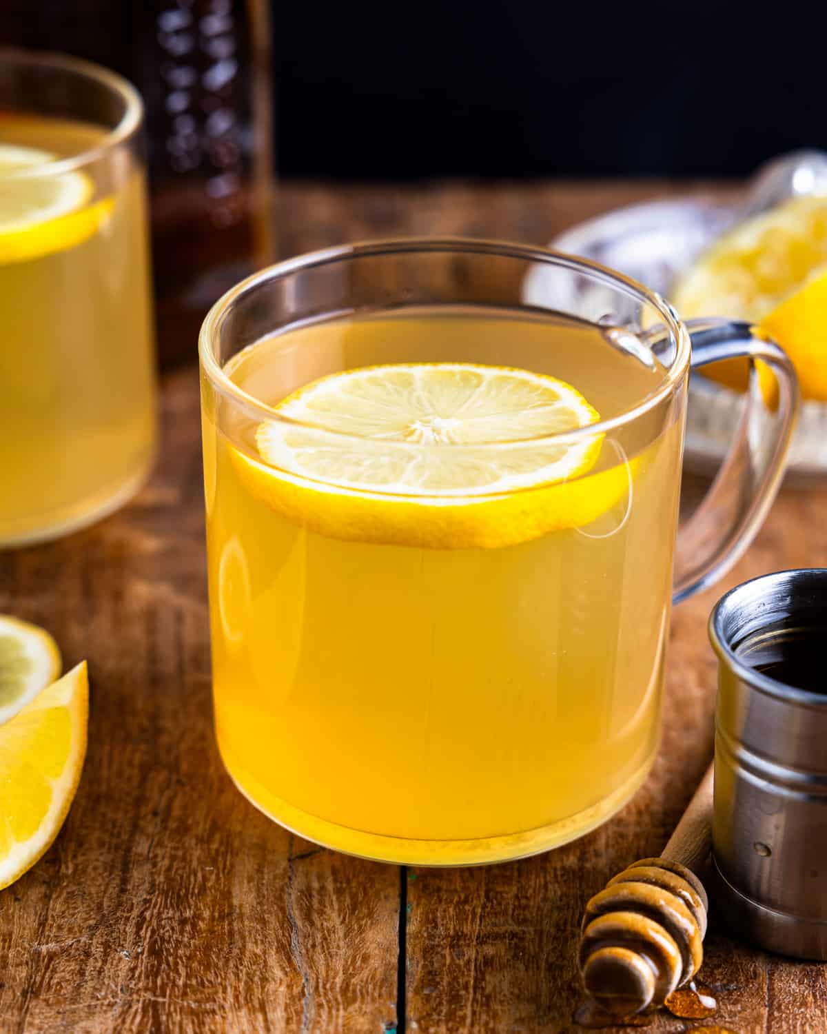 A cup of lemon tea with a slice of lemon.