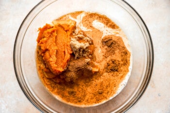 A bowl filled with mashed sweet potatoes and spices.