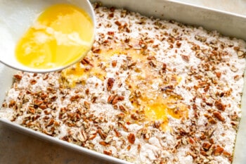 An egg is being poured into a baking dish.