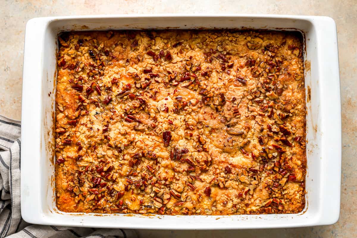 Overhead view of a baked cake with a pecan toppings.