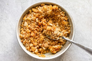 A bowl of granola with a spoon in it.