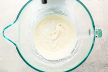 A glass bowl with a white liquid in it.