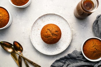 date pudding on a white plate with sticky toffee sauce.