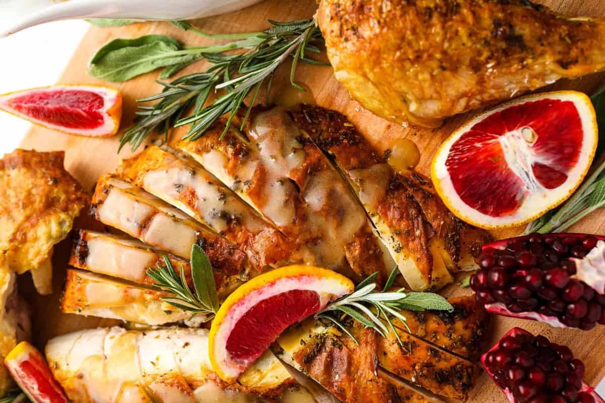 roasted turkey with blood oranges on a cutting board.