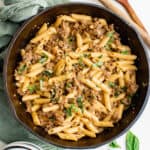 overhead view of sausage pasta in a cast iron pan.