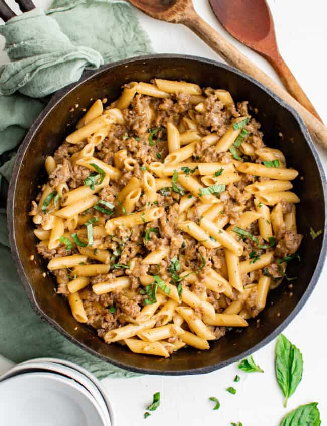 overhead view of sausage pasta in a cast iron pan.