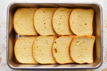 Sliced bread in a pan on a table.