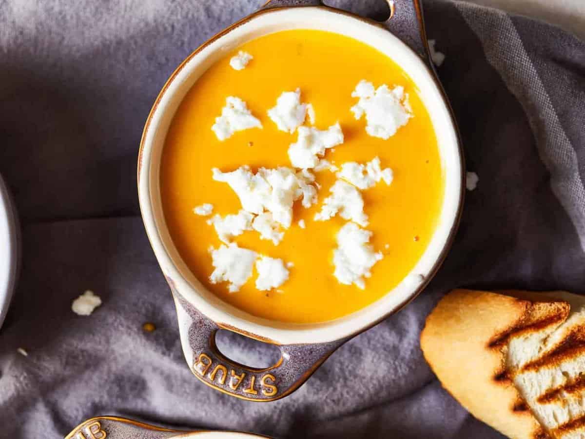 bowl of beer cheese soup with a slice of bread