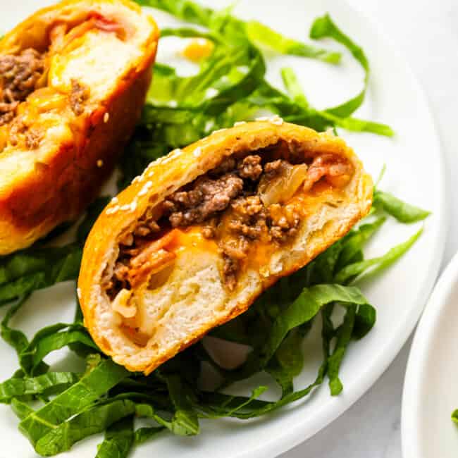 Two cheeseburger bombs on a plate.