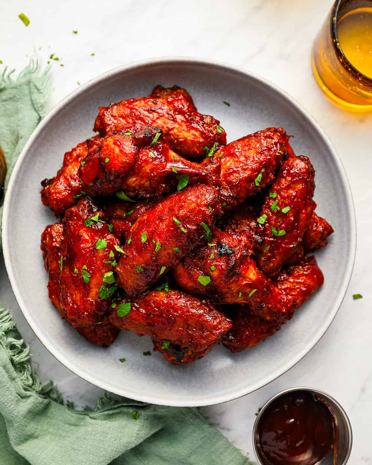 BBQ chicken wings served on a white plate.