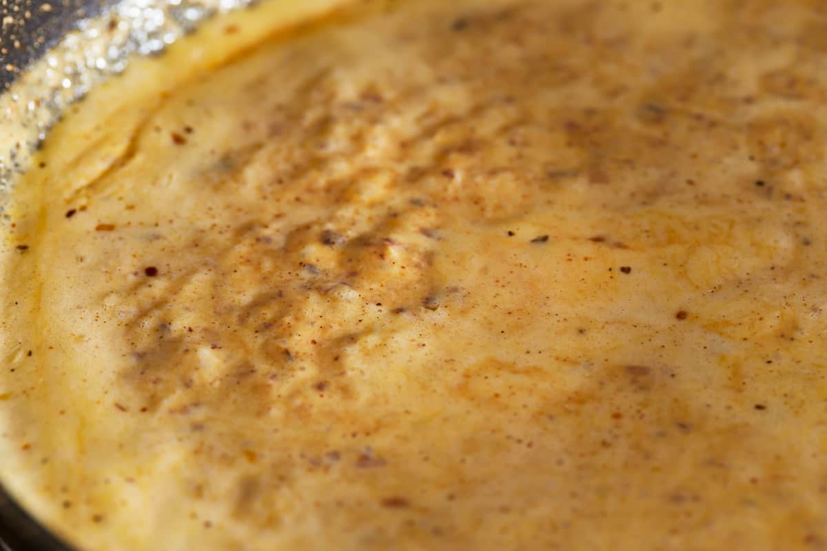 Blackened Alfredo sauce in a frying pan.