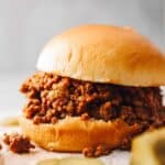 an instant pot sloppy joe sandwich with pickles.