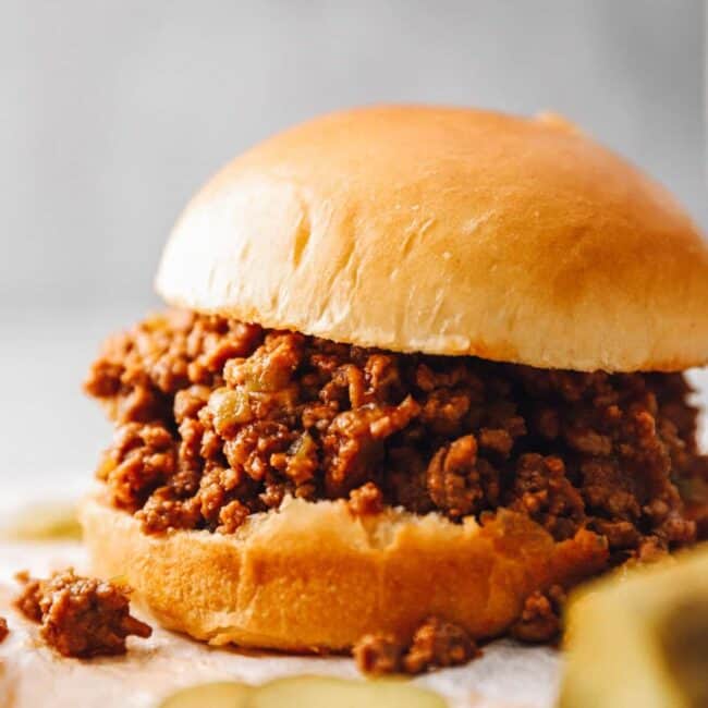 an instant pot sloppy joe sandwich with pickles.