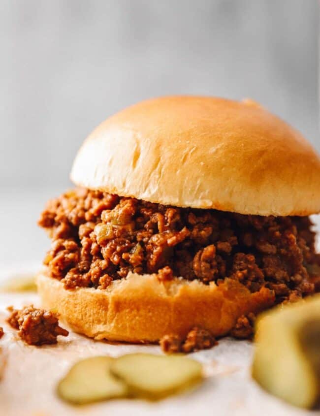 an instant pot sloppy joe sandwich with pickles.