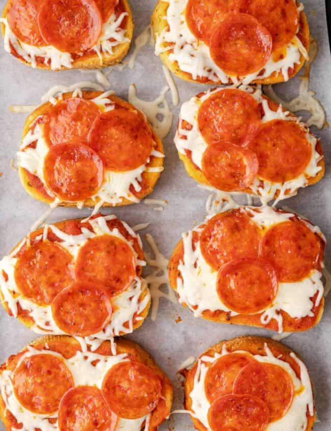 overhead view of 8 slices of texas toast pizza on parchment paper.