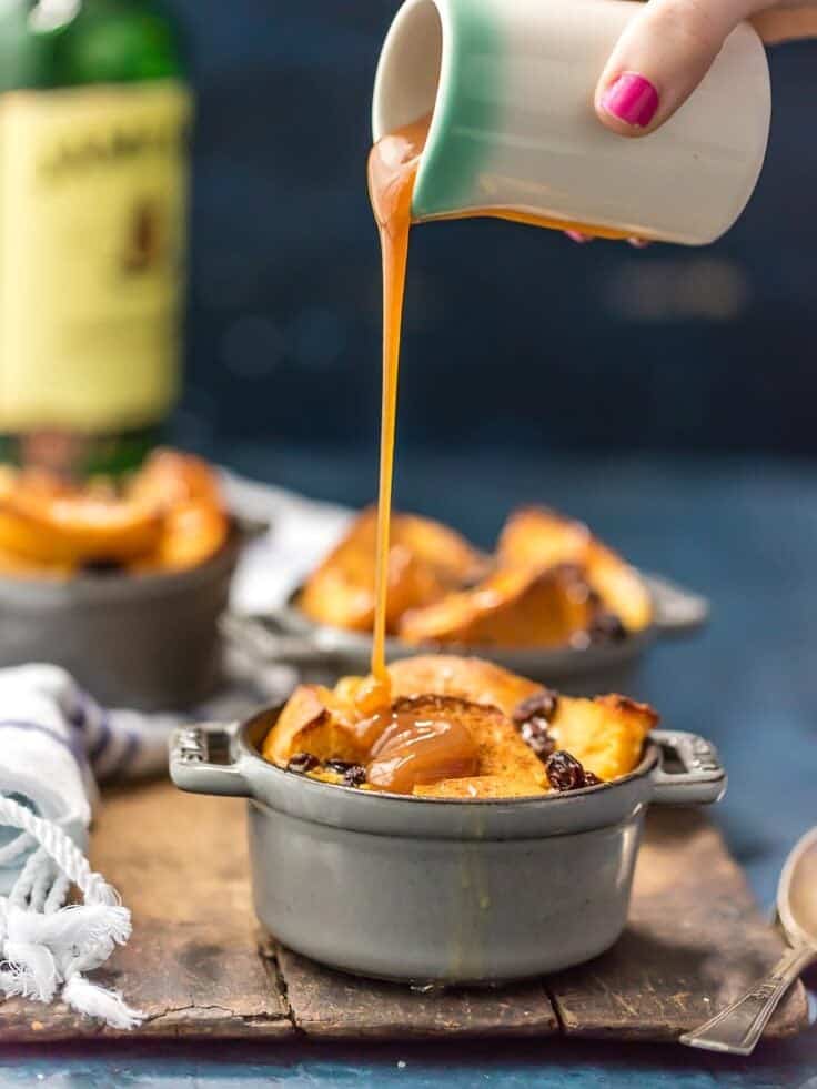 pouring whiskey sauce on top of bread pudding