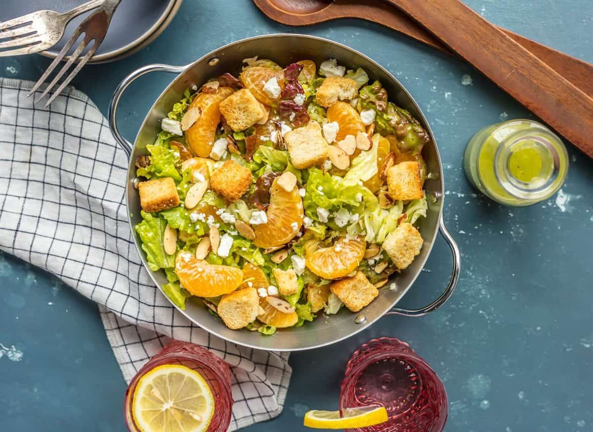 Orange Salad topped with croutons, mandarin oranges, feta, almonds, and more