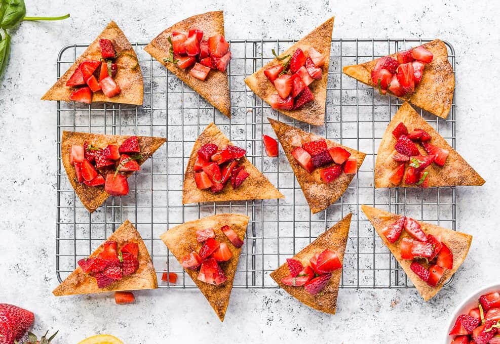 Cinnamon sugar tortilla chips topped with strawberry salsa, on a baking rack