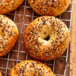 everything bagel seasoned bagels on a wire rack.