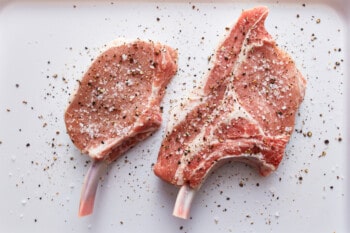 2 seasoned raw pork chops.