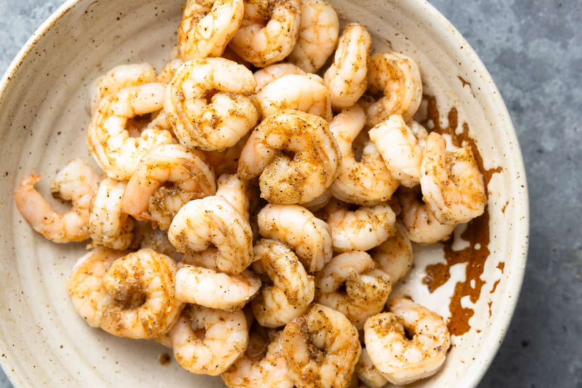 Seasoned shrimp in a pan.