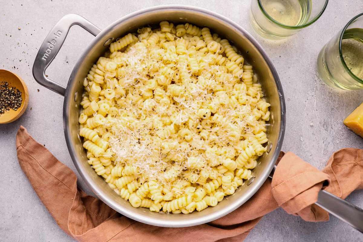 overhead view of cacio e pepe in a stainless steel pot.