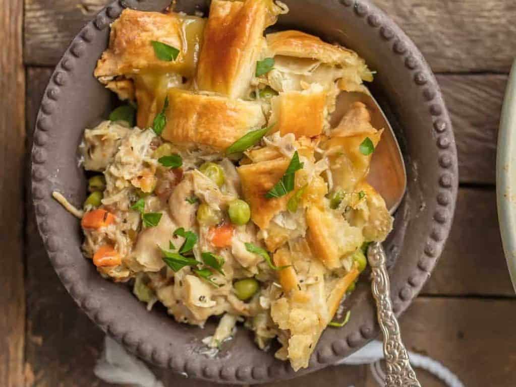 chicken pot pie in a serving dish next to a bowl of it