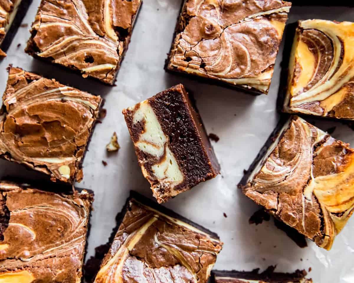 overhead view of cream cheese brownies, one is turned on its side to show the layers.