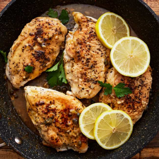 lemon pepper chicken in a pan.