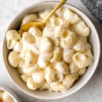 overhead view of a bowl of panera mac and cheese with a spoon.